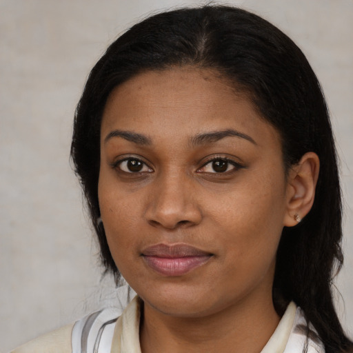 Joyful black young-adult female with medium  brown hair and brown eyes