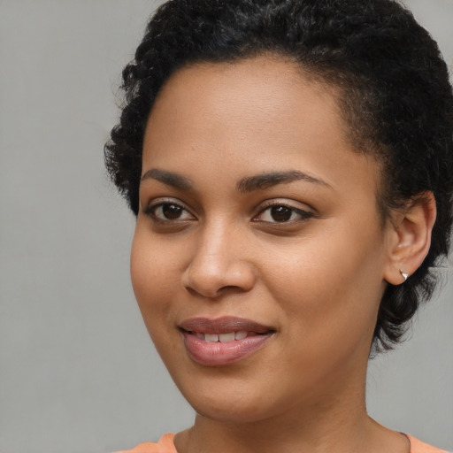 Joyful latino young-adult female with short  brown hair and brown eyes