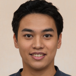 Joyful asian young-adult male with short  black hair and brown eyes