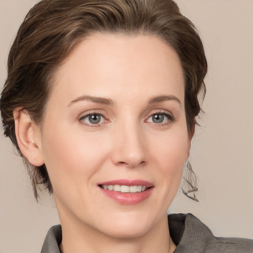 Joyful white young-adult female with medium  brown hair and grey eyes