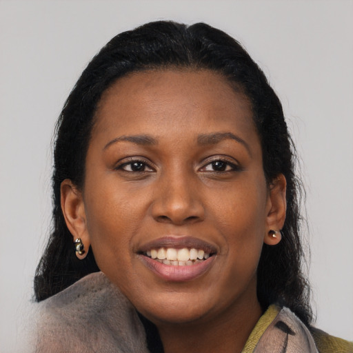 Joyful black young-adult female with medium  black hair and brown eyes