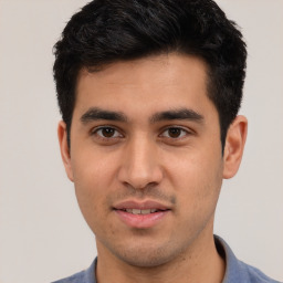 Joyful white young-adult male with short  black hair and brown eyes