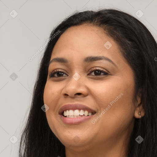 Joyful latino young-adult female with long  black hair and brown eyes