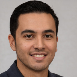 Joyful white young-adult male with short  black hair and brown eyes