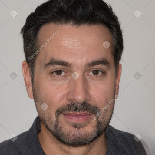 Joyful white adult male with short  black hair and brown eyes