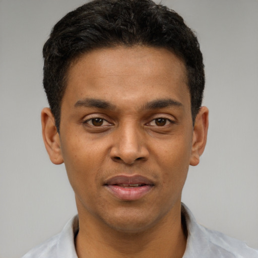 Joyful latino young-adult male with short  black hair and brown eyes