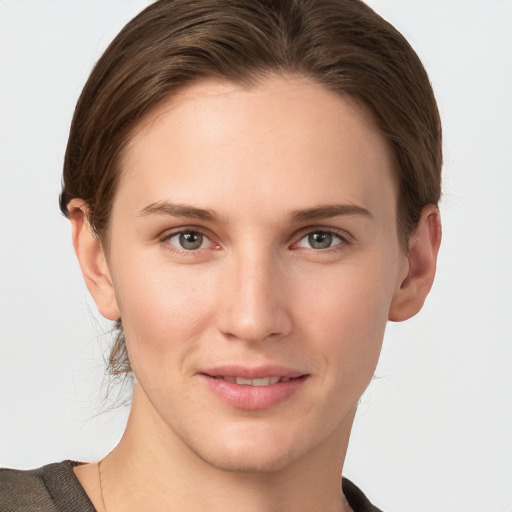 Joyful white young-adult female with short  brown hair and grey eyes