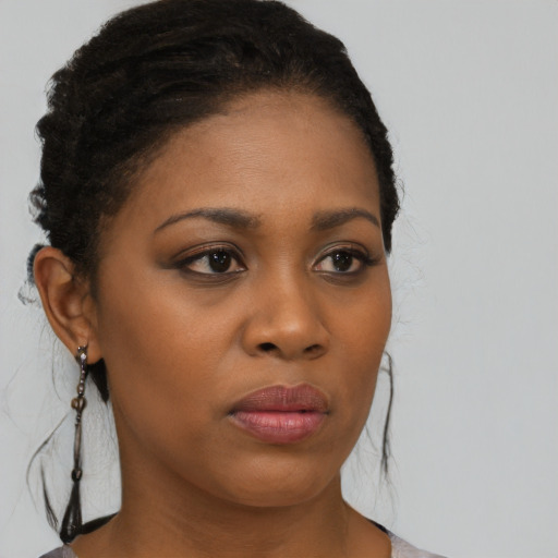 Neutral black young-adult female with medium  brown hair and brown eyes