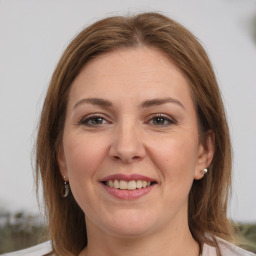 Joyful white adult female with medium  brown hair and brown eyes