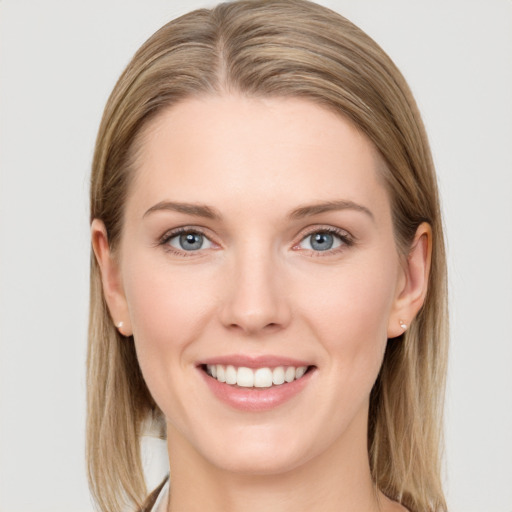 Joyful white young-adult female with long  brown hair and blue eyes