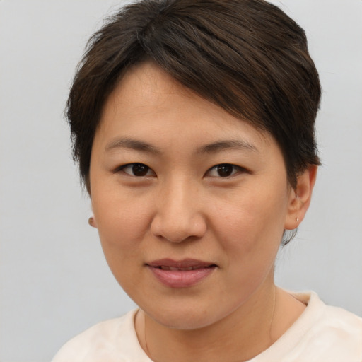Joyful asian young-adult female with short  brown hair and brown eyes