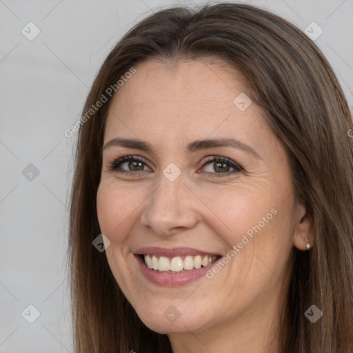 Joyful white adult female with long  brown hair and brown eyes