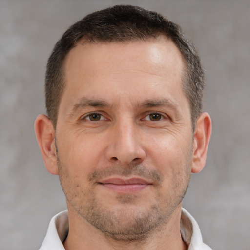 Joyful white adult male with short  brown hair and brown eyes