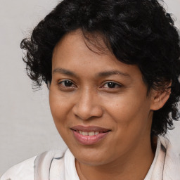 Joyful latino adult female with medium  brown hair and brown eyes