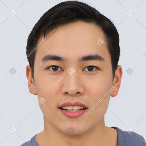 Joyful asian young-adult male with short  black hair and brown eyes