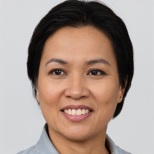 Joyful asian adult female with medium  brown hair and brown eyes