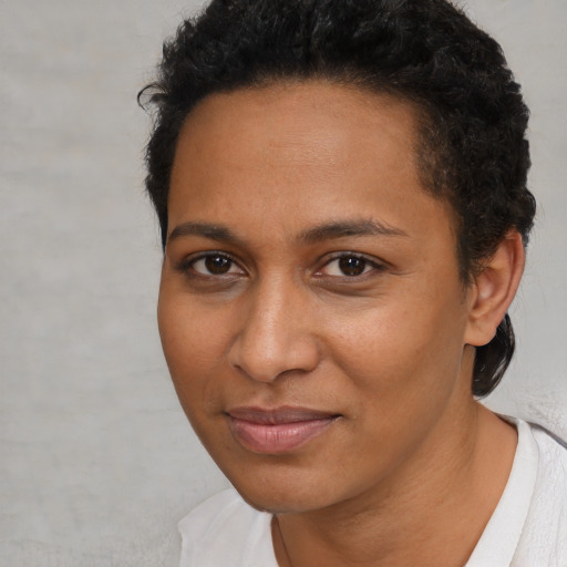 Joyful black young-adult female with short  brown hair and brown eyes