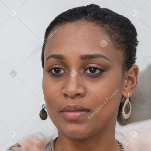 Joyful black young-adult female with short  brown hair and brown eyes