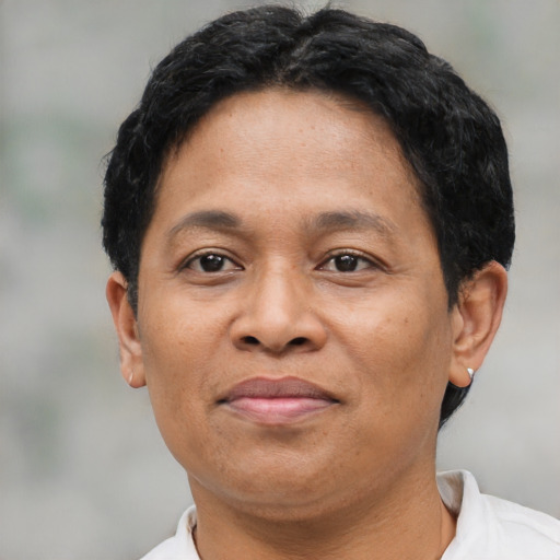 Joyful latino adult male with short  brown hair and brown eyes