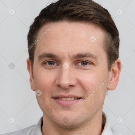 Joyful white young-adult male with short  brown hair and grey eyes