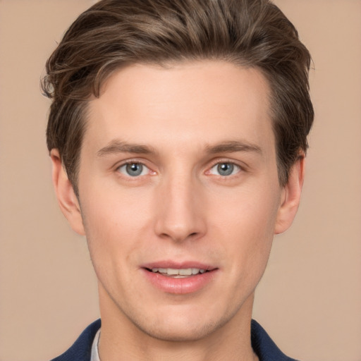 Joyful white young-adult male with short  brown hair and grey eyes