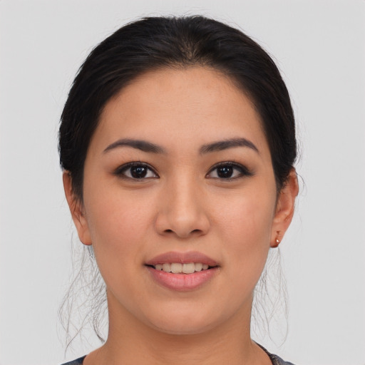 Joyful asian young-adult female with long  brown hair and brown eyes