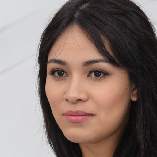 Joyful latino young-adult female with long  black hair and brown eyes