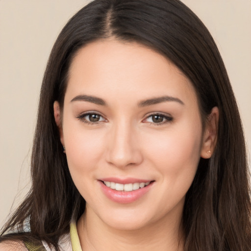 Joyful white young-adult female with long  brown hair and brown eyes