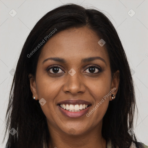 Joyful black young-adult female with long  brown hair and brown eyes