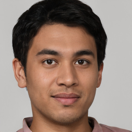 Joyful latino young-adult male with short  black hair and brown eyes