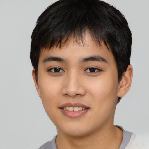 Joyful asian young-adult male with short  black hair and brown eyes