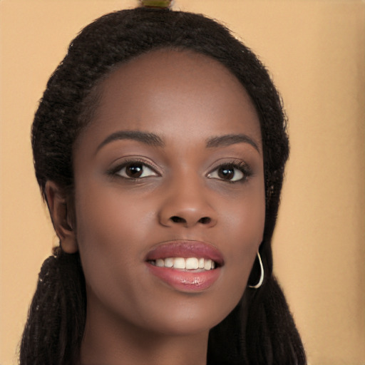 Joyful black young-adult female with long  brown hair and brown eyes