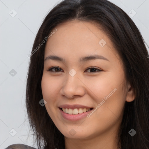 Joyful asian young-adult female with long  brown hair and brown eyes