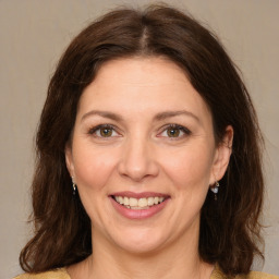 Joyful white adult female with medium  brown hair and brown eyes