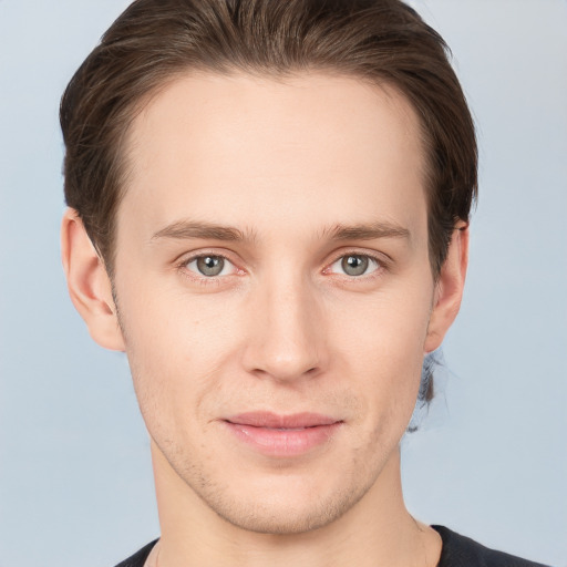 Joyful white young-adult male with short  brown hair and grey eyes