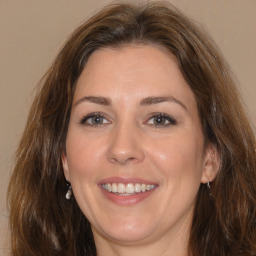 Joyful white adult female with medium  brown hair and brown eyes