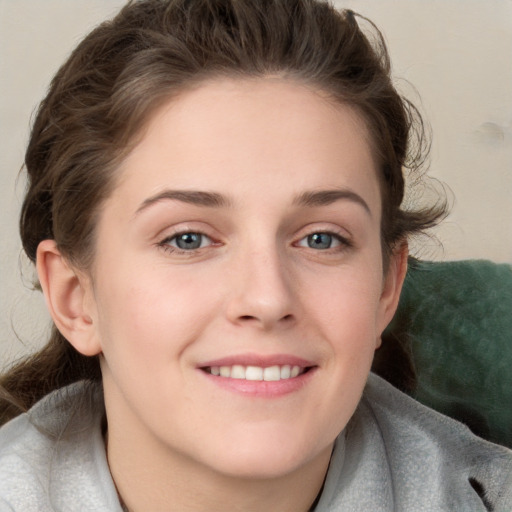 Joyful white young-adult female with medium  brown hair and blue eyes