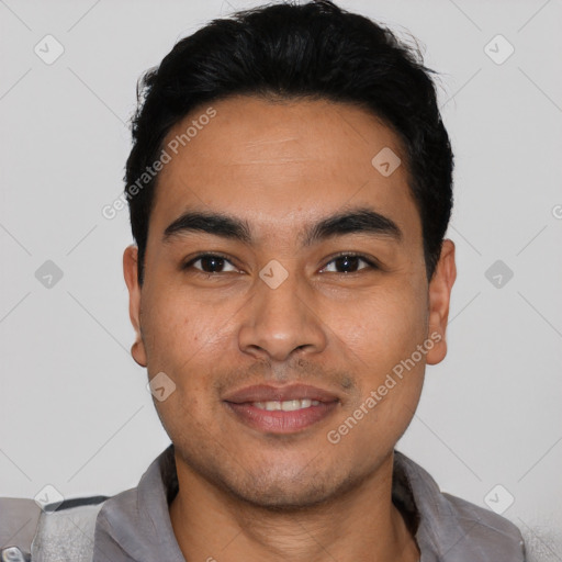 Joyful latino young-adult male with short  black hair and brown eyes