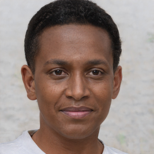 Joyful black young-adult male with short  brown hair and brown eyes