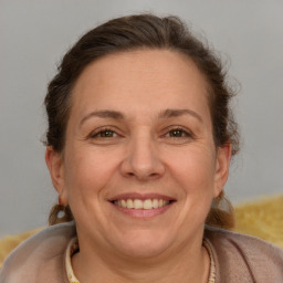 Joyful white adult female with medium  brown hair and brown eyes