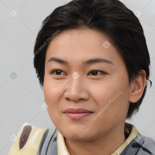 Joyful asian young-adult female with medium  brown hair and brown eyes