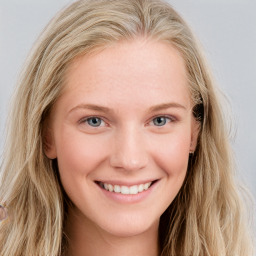 Joyful white young-adult female with long  brown hair and blue eyes