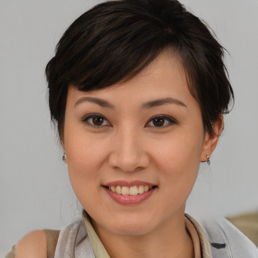 Joyful asian young-adult female with medium  brown hair and brown eyes