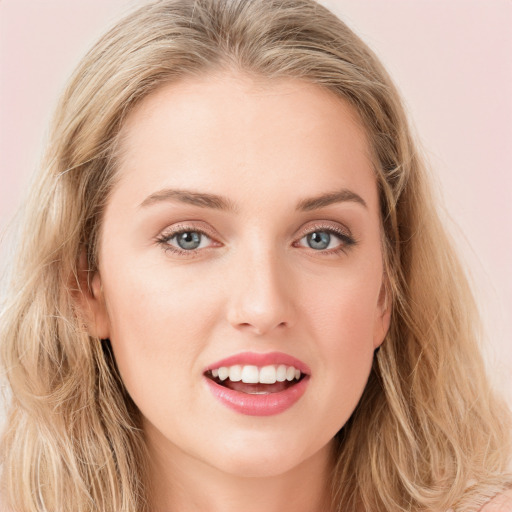 Joyful white young-adult female with long  brown hair and blue eyes