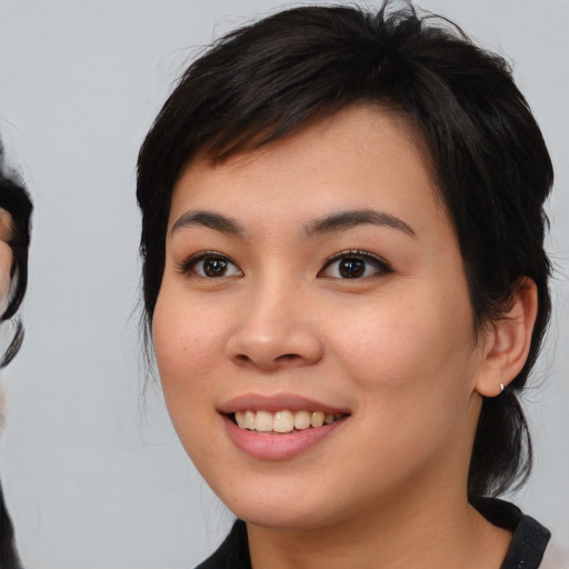 Joyful white young-adult female with medium  black hair and brown eyes