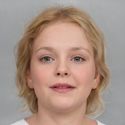 Joyful white young-adult female with medium  brown hair and blue eyes