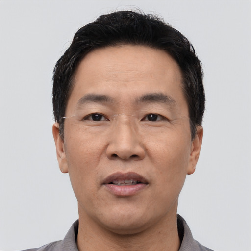 Joyful asian adult male with short  black hair and brown eyes