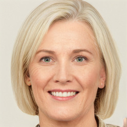 Joyful white adult female with medium  blond hair and green eyes