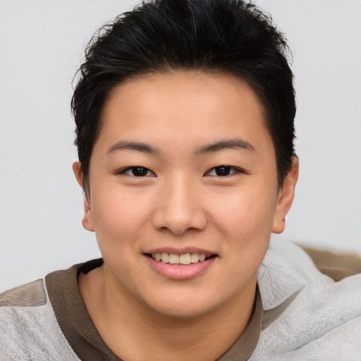 Joyful asian young-adult female with short  brown hair and brown eyes