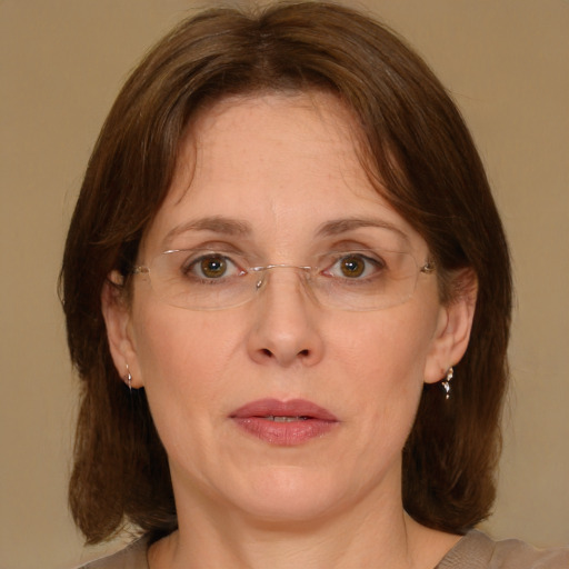 Joyful white adult female with medium  brown hair and green eyes